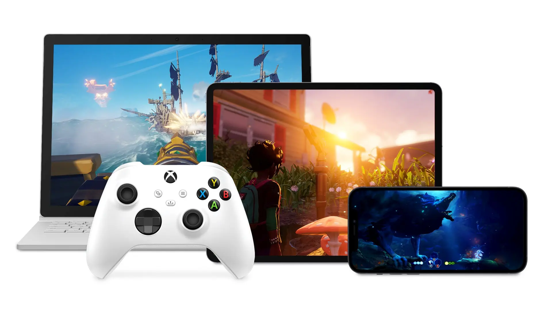 Xbox games streaming to a laptop, a tablet and a phone, with a white wireless controller in front